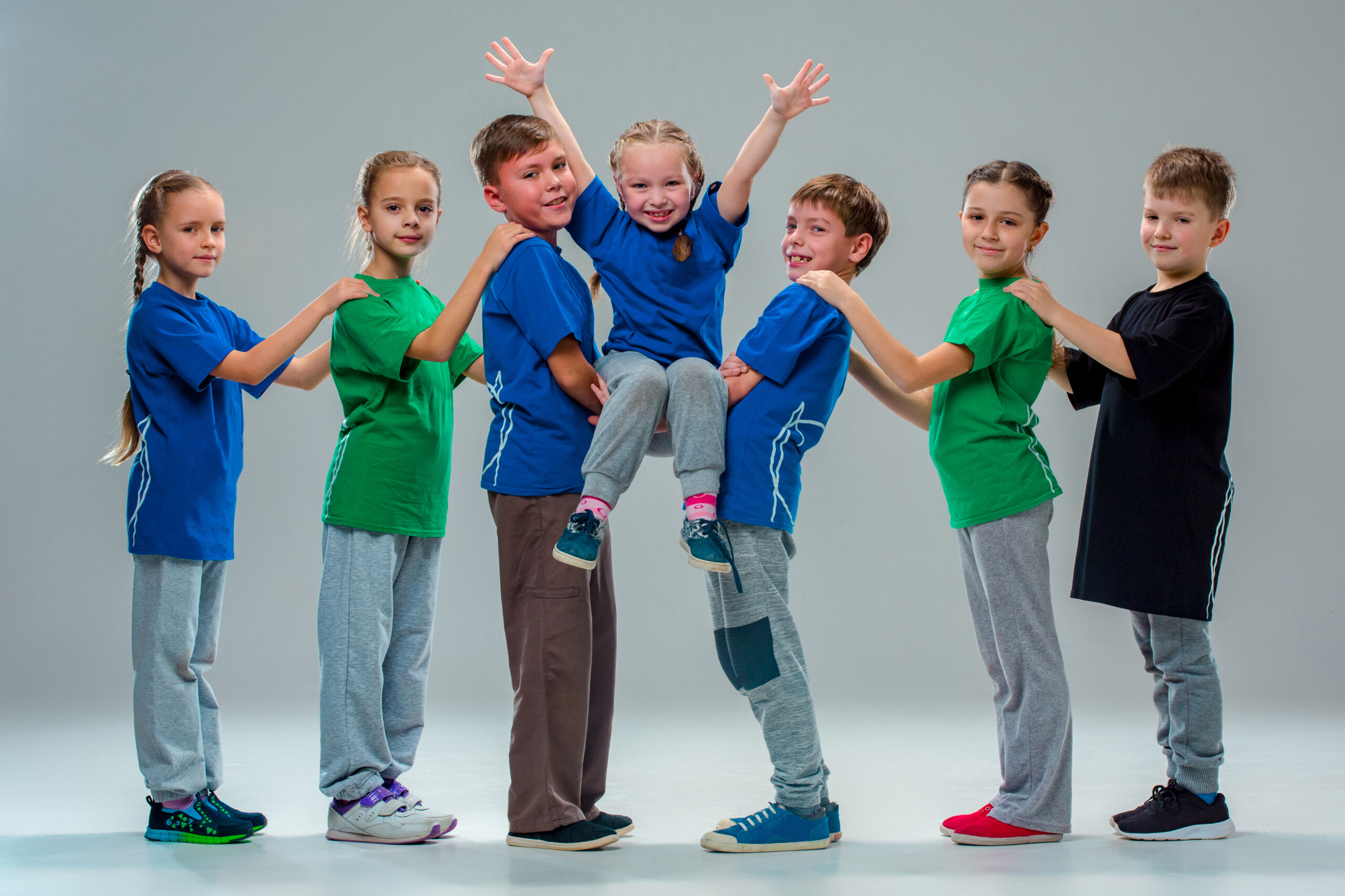 The kids dance school, ballet, hiphop, street, funky and modern dancers on gray studio background